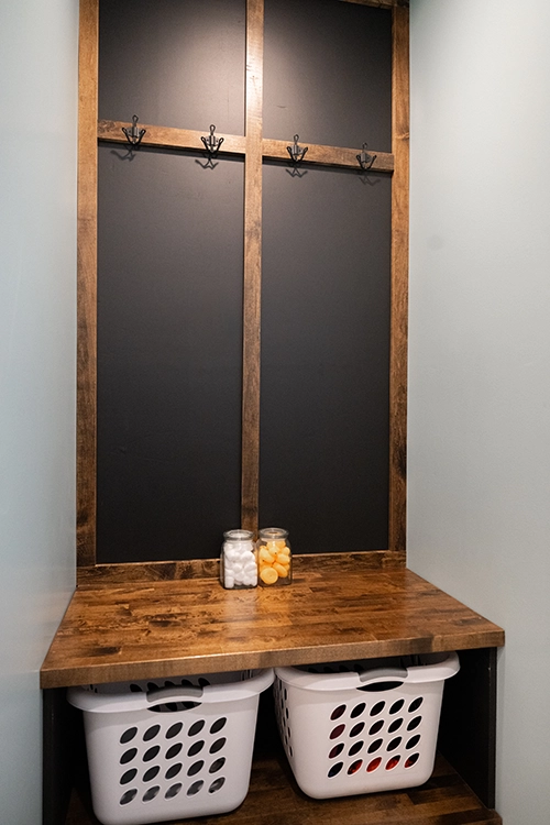 laundry room basket holder and wood wall design with hooks
